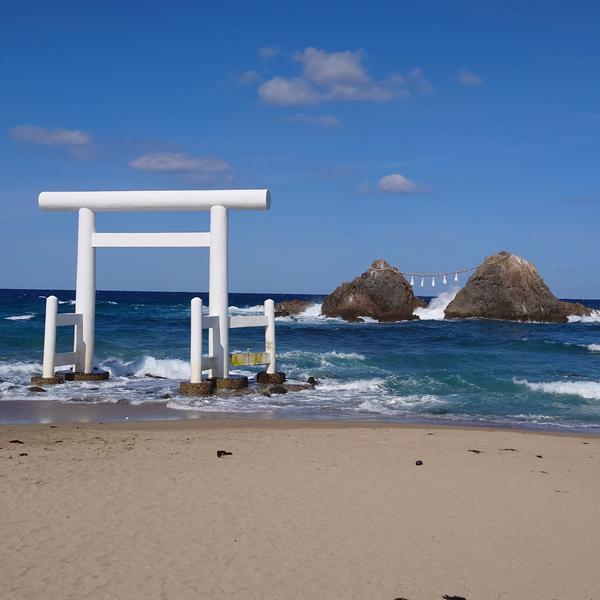 White torii gate on a beach in Itoshima