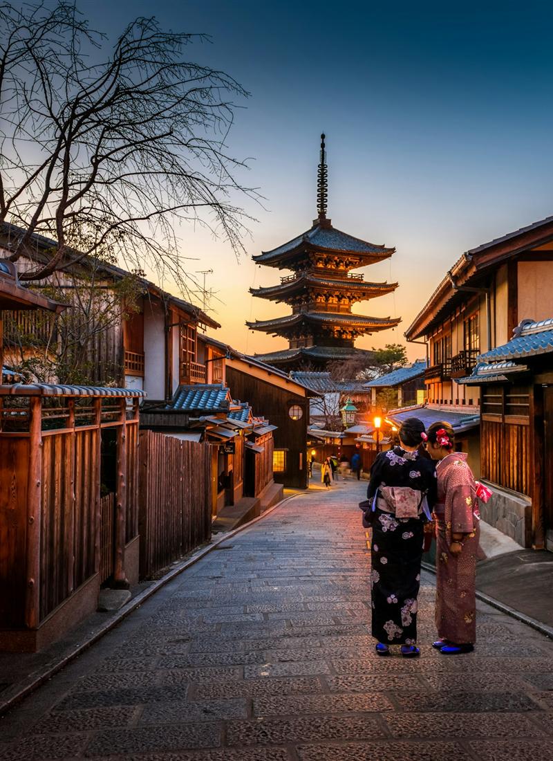 Yasaka Pagoda rising above a lantern-lit Kyoto street at dusk
