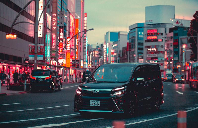 Private van driving through a Tokyo street